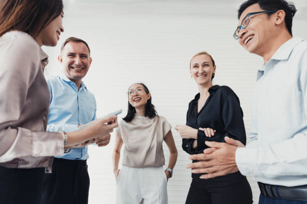 istock Group of professionals engaging in a lively discussion in a bright office setting during a workday 2186062603