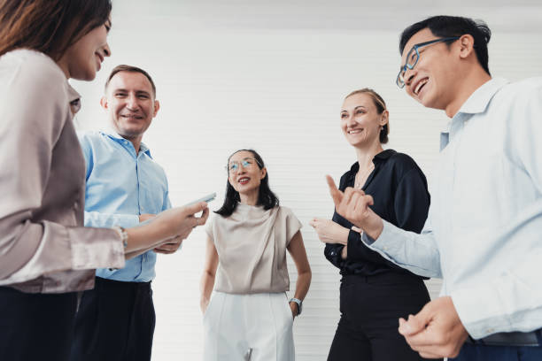 istock Group of professionals engaging in conversation at a modern office setting during a team meeting 2186062633