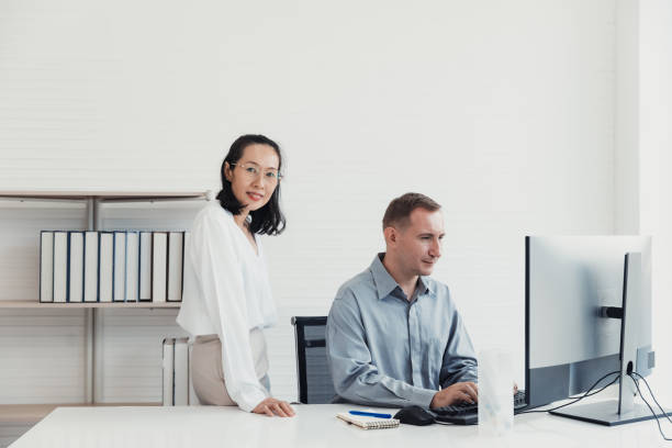 istock Colleagues collaborating at a modern office desk during a productive work session 2186064071