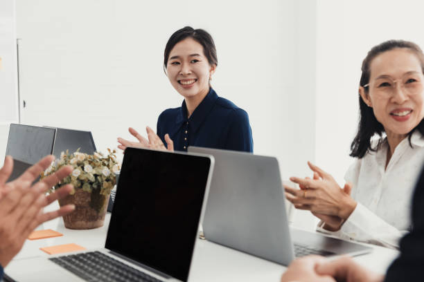 istock Team members celebrate a successful meeting in a modern office environment with smiles and applause 2186064719