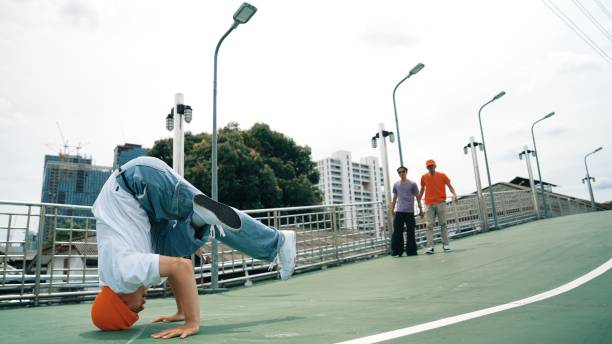 istock Professional asian hipster walking while doing freeze pose at bridge. Sprightly. 2186091051