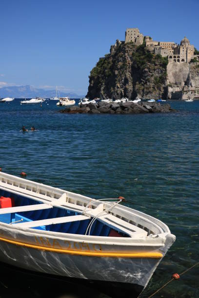 Ischia, Naples, Italy, About the July 2019.  Ancient Aragonese Castle in Ischia Ponte. The fortification stands on a peninsula of volcanic rock connected to the village of Ponte. Boats