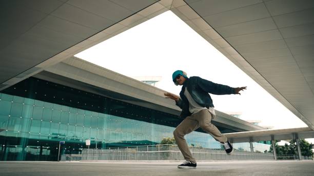 istock Happy hipster practice b boy dance with stylish cloth at building. Sprightly. 2186101653