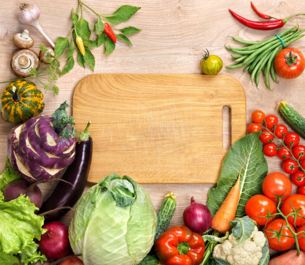 istock Healthy food background and Copy space / studio photography of open blank ring bound notebook surrounded by a fresh vegetables and pencil on old wooden table 2186103188