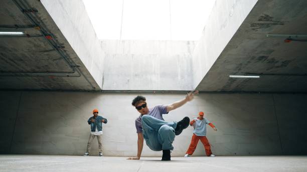 istock Group of stylish hipster group perform dancing together in building. Sprightly. 2186104016