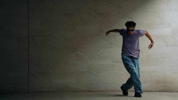 istock Skilled smart street dancer practice b-boy movement in building. Sprightly. 2186104989