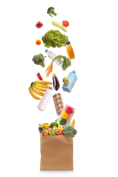 istock Studio shot of groceries falling in a paper bag 2186106594