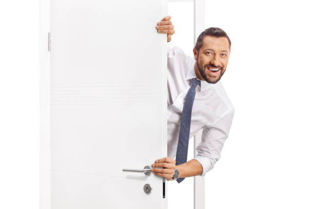 istock Cheerful businessman standing behind a door 2186106611