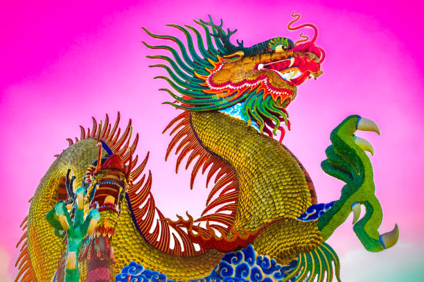 Nakhon Sawan Series : Golden dragon statue in Chinese style with pink sky. Landmark of Nakhon Sawan Province. Dragon sculpture with sweet sky.