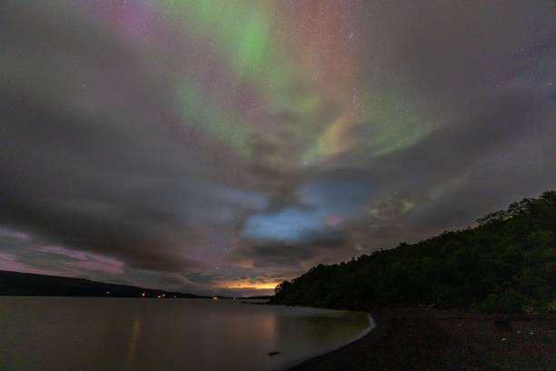 istock Aurora borealis over a serene lakeside. 2186118740