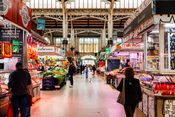 Facade of the Art Nouveau market 'Mercat Central' illuminated from inside in the night in Valencia, Spain
