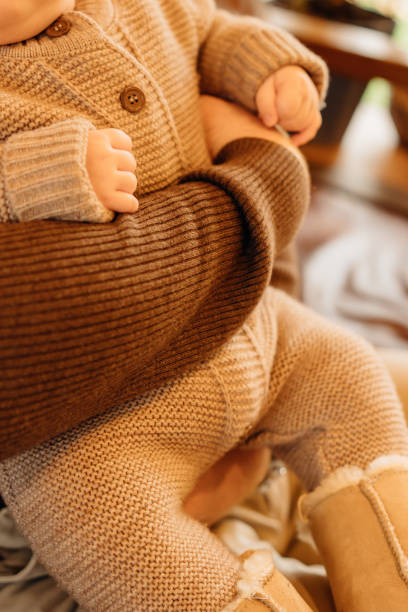 istock a child in a knitted brown suit and warm boots. 2186121786
