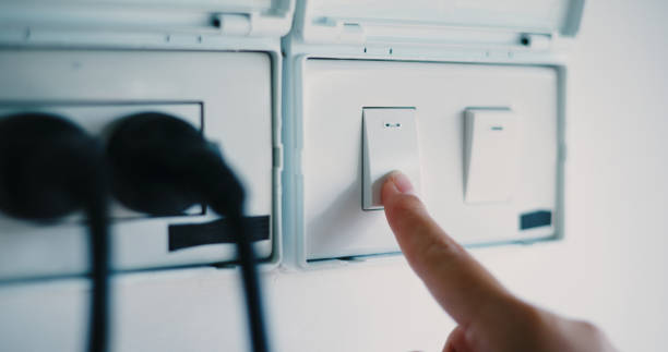 istock Close-up of hand press the switch to turn on the light. 2186125497
