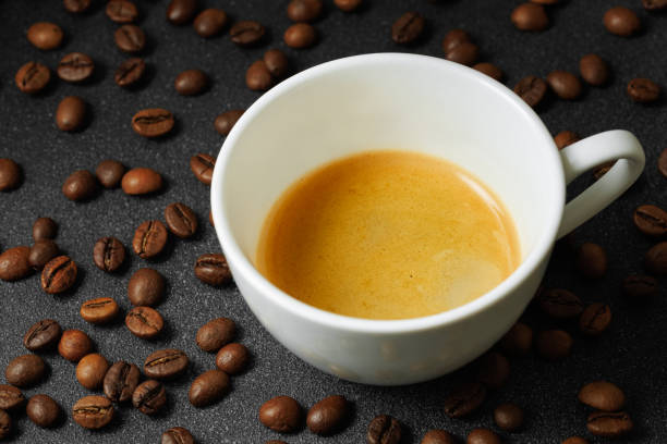 istock ristretto with crema in cup and coffee beans near on black table 2186128580