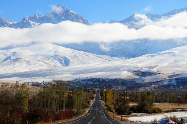 istock Snowy mountains and highway view 2186142147