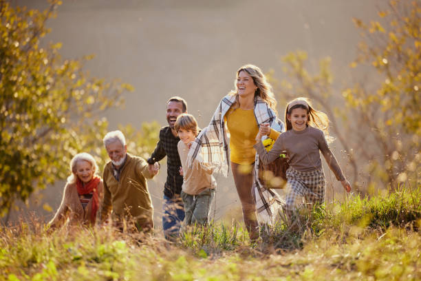 istock Happy extended family having fun while going on a picnic in autumn day. 2186149685