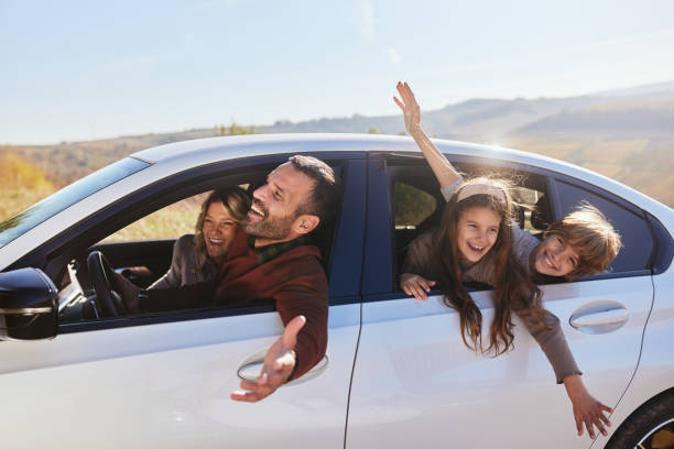 istock Cheerful family having fun during a trip by a car. 2186149855