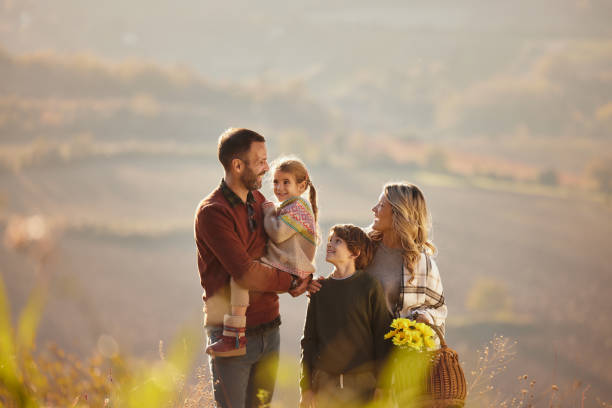 istock Happy family talking during autumn day on a hill. 2186150116