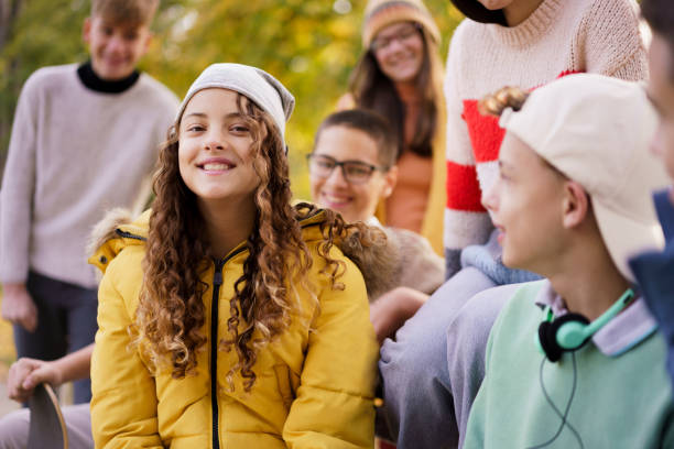 istock Teenagers are talking while sitting on a park bench 2186150167