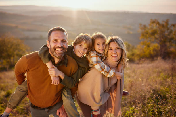 istock Happy family having fun while piggybacking in autumn day. 2186150511