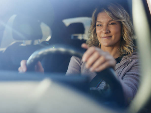 istock Smiling woman enjoying while going on a trip by car. 2186151976