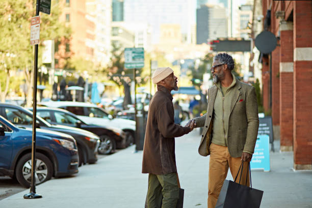 istock Mature Black men greeting each other in downtown Chicago 2186158585