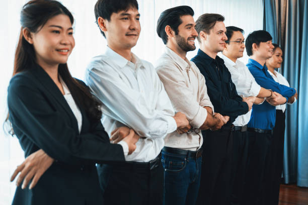 istock Business team standing, join and link hand together. Prudent 2186160585