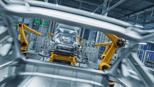 istock Autonomous Factory with Robotic Arms Autonomously Assembling Car Frames At the Factory. Artificial Intelligence, Precision Production, and Manufacturing Green Energy EVs Plant 2186166559