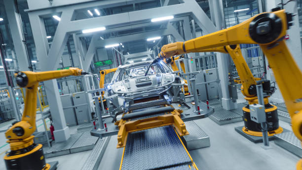 istock Autonomous Factory with Robotic Arms Autonomously Assembling Car Frames At the Factory. Artificial Intelligence, Precision Production, Manufacturing of Sustainable, Green Energy EVs Plant 2186166644