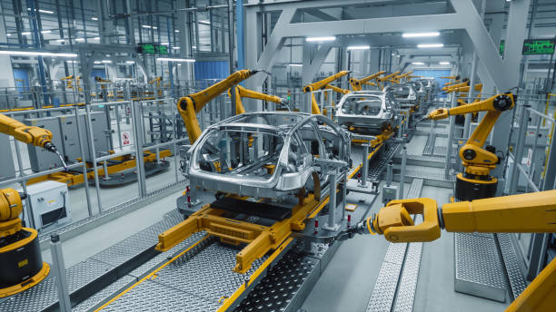 istock Autonomous Factory with Robotic Arms Autonomously Assembling Car Frames At the Factory. Artificial Intelligence, Precision Production, Manufacturing of Sustainable, Green Energy EVs 2186166681