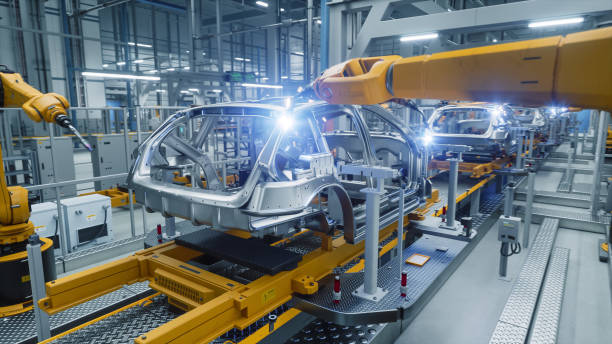 istock Autonomous Factory with Robotic Arms Autonomously Assembling Car Frames At the Factory. Artificial Intelligence, Precision Production, Manufacturing of Sustainable, Green Energy Electric Vehicles 2186166712