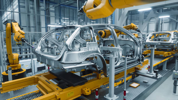 istock Autonomous Factory with Robotic Arms Autonomously Assembling Car Frames At the Factory. Artificial Intelligence, Precision Production, and Manufacturing of Sustainable, Green Energy Electric Vehicles 2186166748