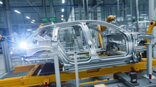 istock Autonomous Factory with Robotic Arms Autonomously Assembling Car Frames At the Factory. Artificial Intelligence, Precision Production, and Manufacturing of Sustainable, Green Electric Vehicles 2186166763