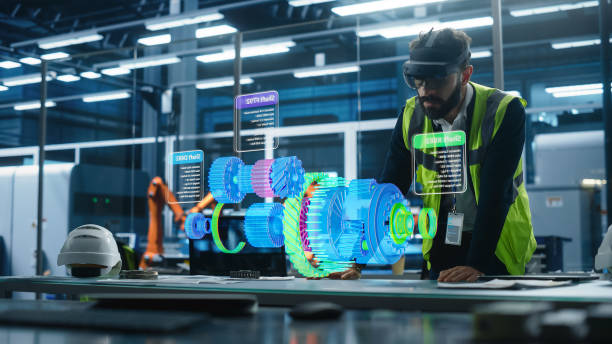 istock Male Engineer Uses an Augmented Reality Headset to Interact With Holographic Model of Engine in a High Tech Factory, Showcasing Innovative Manufacturing Processes and Advanced Digital Visualization 2186167669