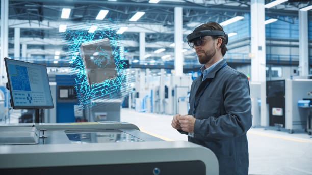 istock Male Engineer Uses Augmented Reality Headset to Interact With Complex 3D Holographic Model of Microchip in an Advanced Manufacturing Facility, Precision Engineering of PC Hardware in the Factory 2186169248