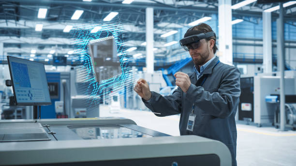 istock Male Engineer Uses Augmented Reality Headset to Interact With Complex 3D Holographic Model of Microchip in an Advanced Manufacturing Facility, Precision Engineering of Computer Hardware in the Factory 2186169392