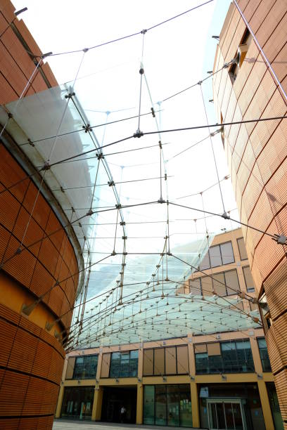 Modern building with glass roof and brick facade. Banco Popolare Palace in Lodi designed by the architect Renzo Piano. Lodi, Lombardy, Italy about 09-2021.Modern building with glass roof and brick facade. Banco Popolare Palace in Lodi designed by the architect Renzo Piano. Headquarters of the former Banca Popolare di Lodi in Via Polenghi Lombardo. built on an abandoned industrial area, it houses, besides the bank offices, an auditorium, negoni, bar. Some circular towers evoke the typical industrial buildings of the area. lodi italy stock pictures, royalty-free photos & images