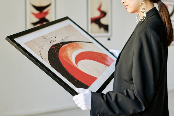 istock Holding Framed Abstract Painting in Art Gallery 2186177720