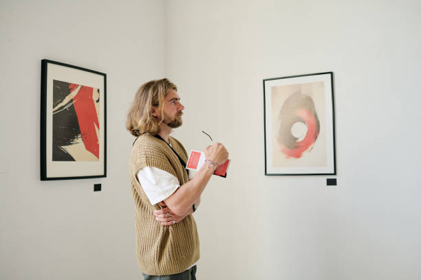 istock Contemplating Abstract Artwork in Minimalist Gallery 2186179686