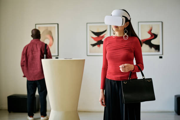 istock Woman Using Virtual Reality Headset in Art Gallery 2186180880