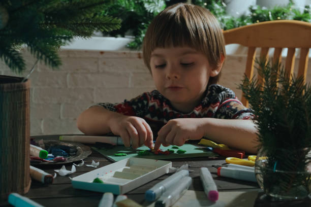 istock Small child making handmade Christmas greeting card. 2186181635