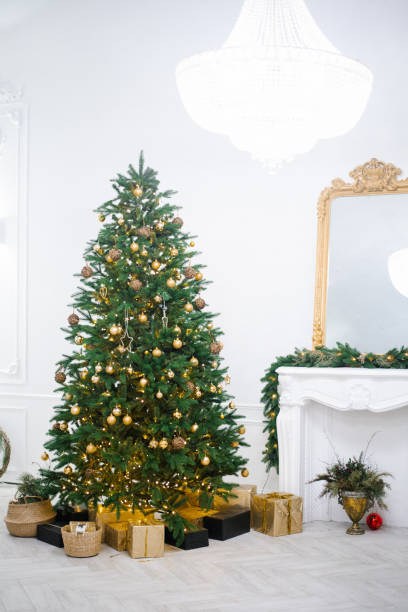 istock Festive interior with decorated Christmas tree and fireplace 2186182822