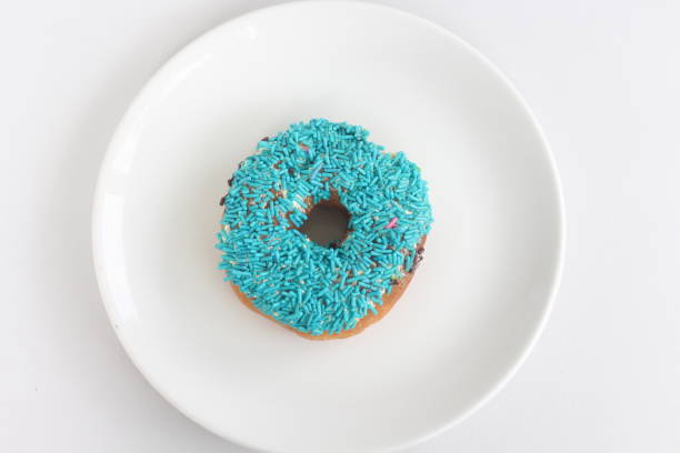 Blue donut in glaze on a white background. Great fresh tasty cyan donut drizzled with glaze
