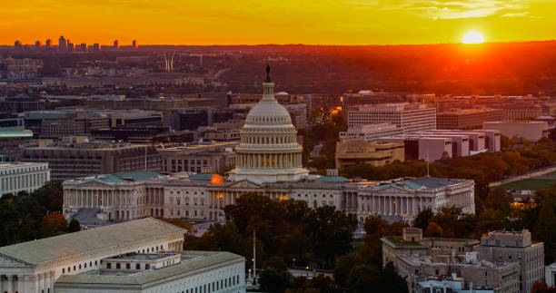 istock Aerial Shot of Sun Setting Behind US Capitol Building 2186186937