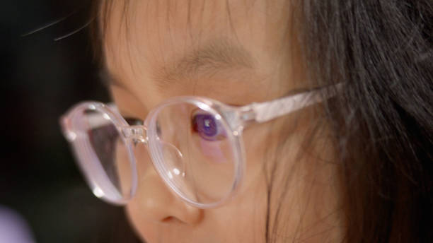 istock Asian girl enjoy playing game on tablet on sofa at home. 2186190806