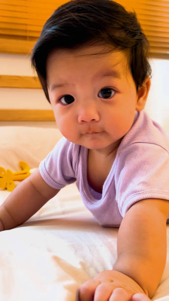 istock Asian Baby boy learning to crawl on the bed. 2186192040
