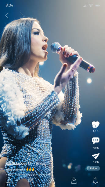 istock Vertical Mobile Interface: Social Media Mockup App With Beautiful Female Singer Dressed In Gorgeous Outfit Performing Her Hit Song During Concert. Ideal Template for Social Media Posts and Stories. 2186193026