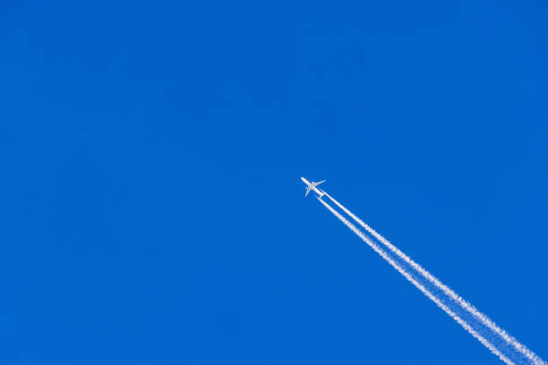 Airplane leaving a trail in a blue sky