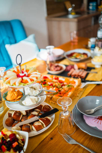 istock Delicious Brunch Spread with Fresh Pastries, Fruit Platter, Creamy Dips, and Savory Pizza on a Wooden Table 2186198537