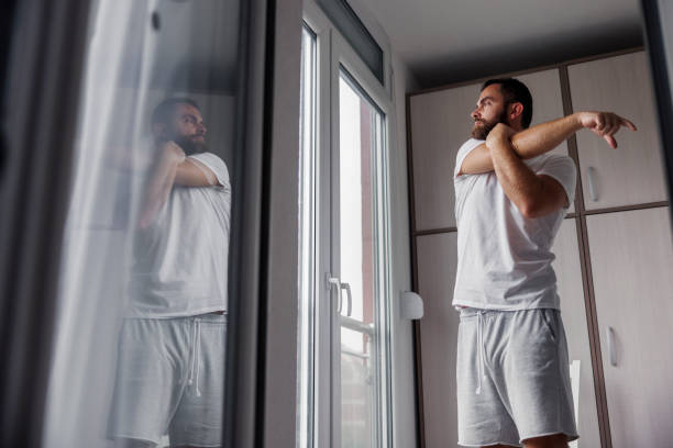 istock Man stretching out while working out at home in the morning 2186201740